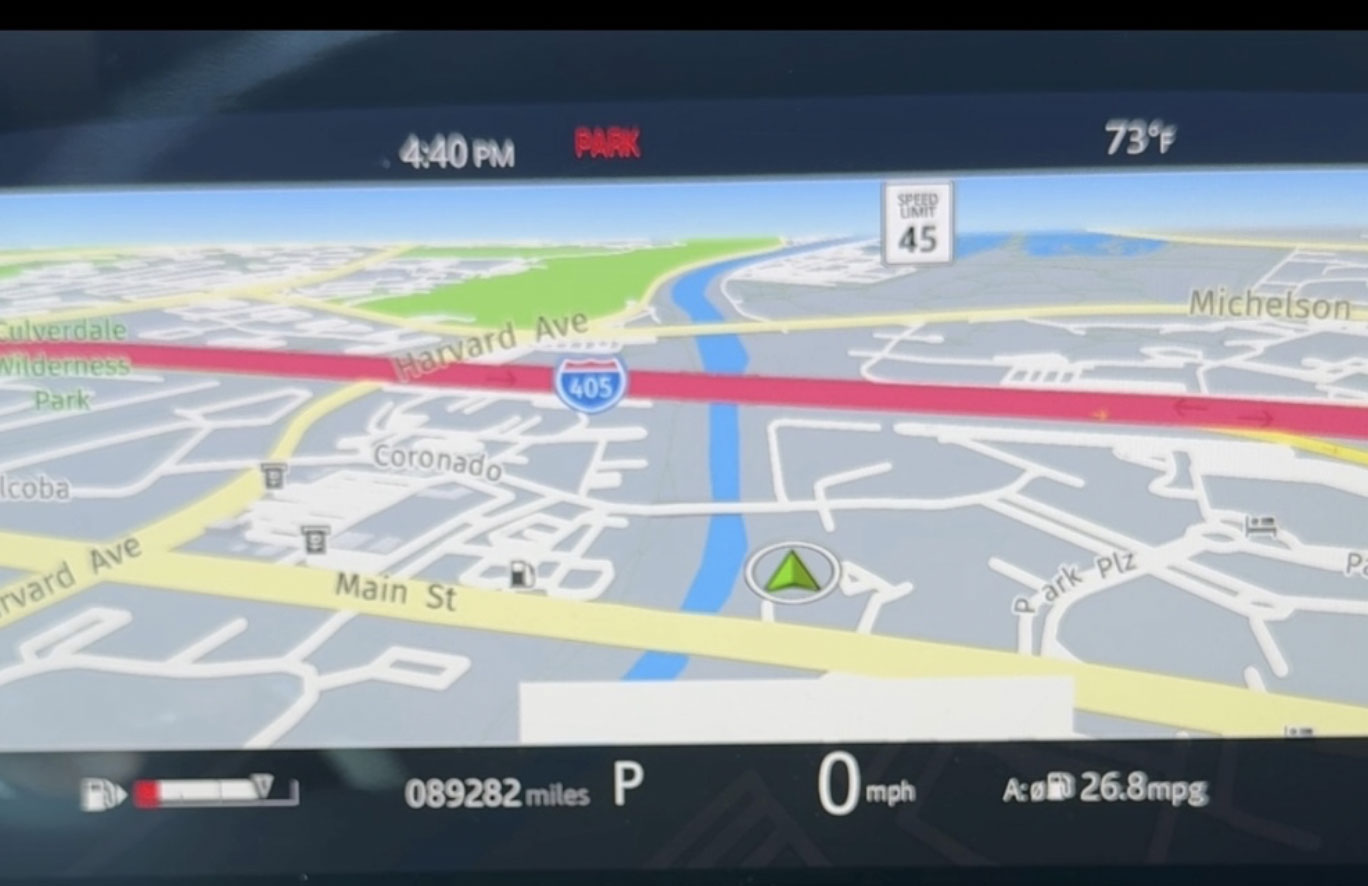 Dashboard of a Range Rover showing improved MPG with system active